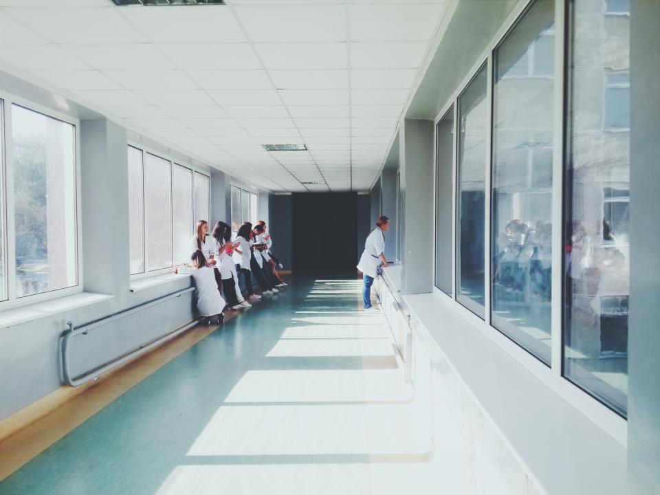 Bright hospital corridor with clinical staff at work