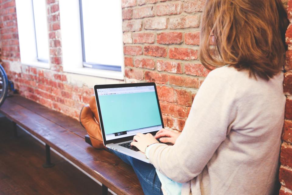 Support specialist responding to customers from a laptop