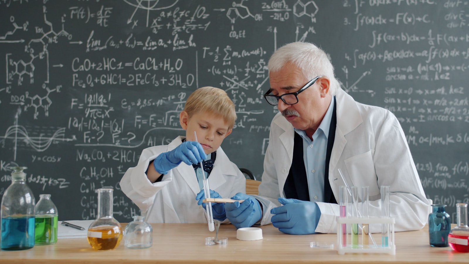 Pupils and a teacher working through a science experiment